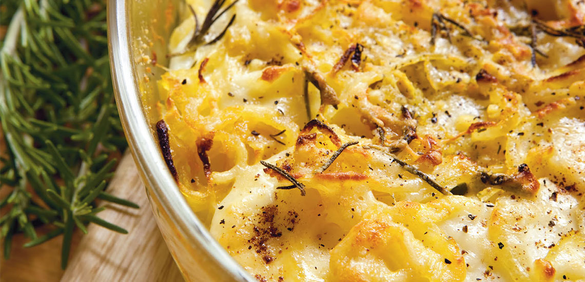 Golden onions and potatoes au gratin with rosemary